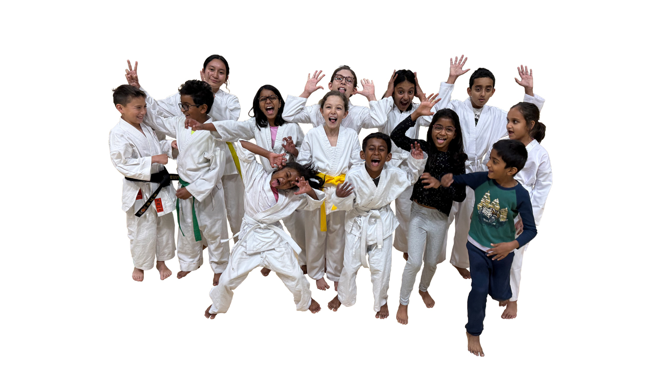 Joyful diverse group of kids in white gi practicing karate together
